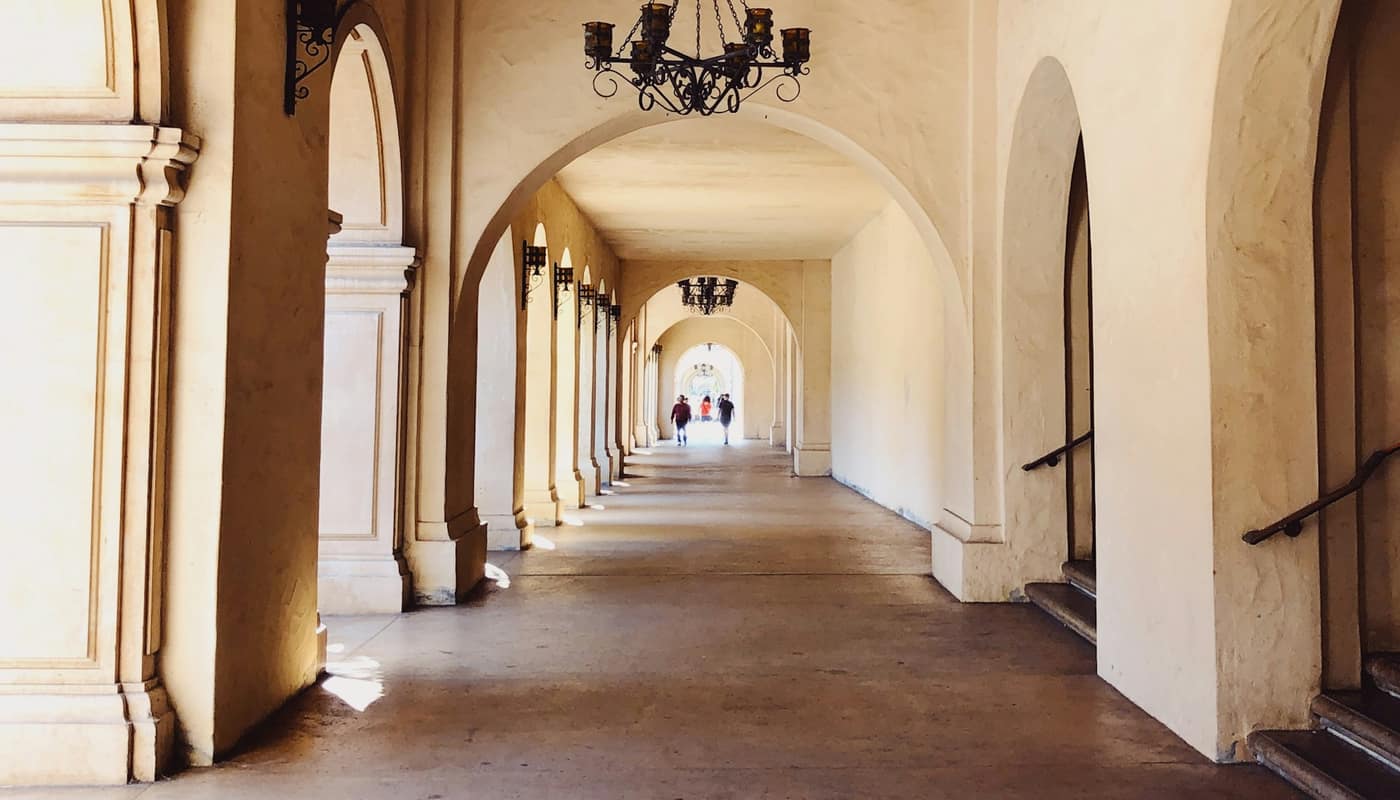 A Spanish Colonial arcade with arches and tiled floors